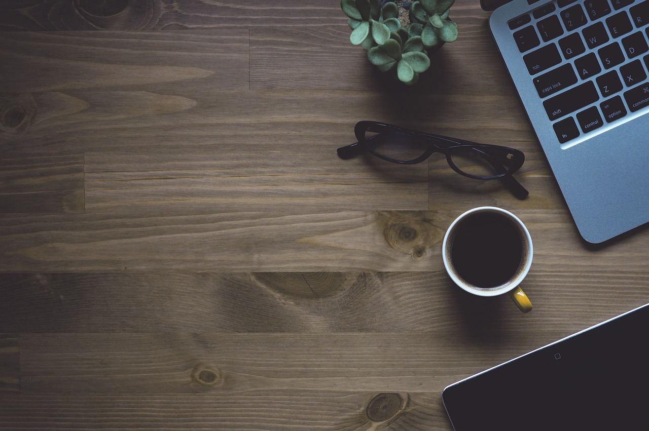 Workspace, coffee, laptop — Why is a desktop wallet considered to be a hot wallet?